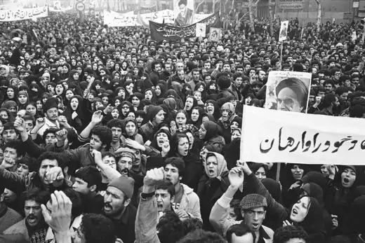 A poster of exiled Muslim leader Ayatollah Khomeini is carried by marchers with clenched fists during the anti-Shah demonstrations in Tehran.
