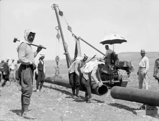 The Red Line Agreement: Workers for the Iraq Petroleum Company connect an oil pipeline in July 1933.