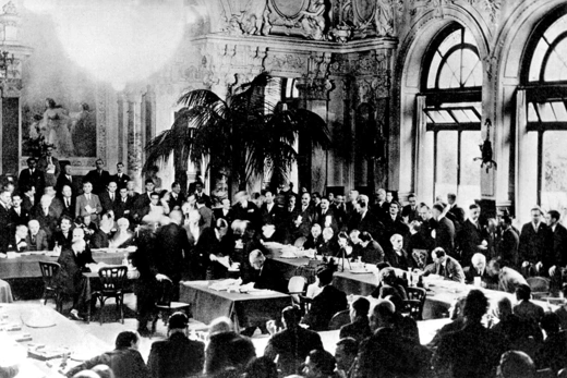 Representatives from France, Germany, and the United Kingdom meet at the Lausanne Conference of 1932 to discuss suspending reparations imposed on countries defeated in World War I.