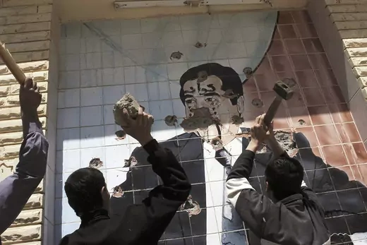 A portrait of Saddam Hussein is shown being destroyed in Kirkuk on April 10, 2003. Kurdish troops captured Kirkuk with the aid of American troops during the U.S. invasion of Iraq.  