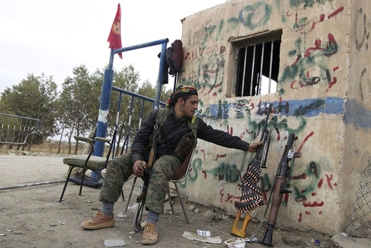 A YPG fighter at a checkpoint near Ras al-Ain in Syria on November 5, 2013. Kurdish militias had recaptured the city and its surrounding villages from Islamist rebels, leading to a declaration of autonomy in northern Syria. 