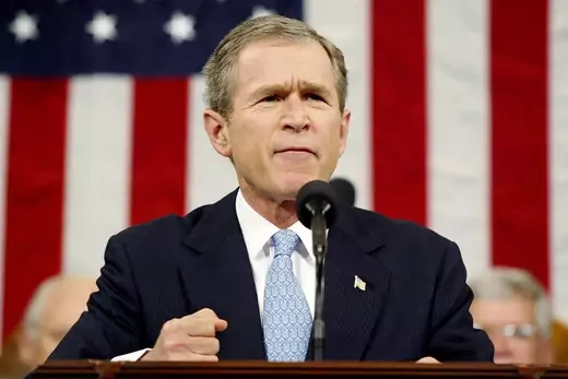 President George W. Bush delivers the 2002 State of the Union speech in front of a large American flag