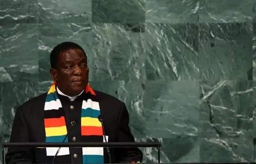 The President of Zimbabwe Emmerson Dambudzo Mnangagwa stands in front of a dark green background while addressing leaders at the United Nations General Assembly. 