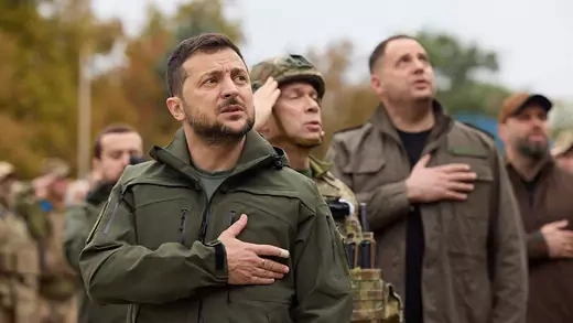 Ukraine's President Zelensky sings a national anthem on September 14, 2022 during a flag rising ceremony in the recently liberated town of Izium in the Kharkiv region