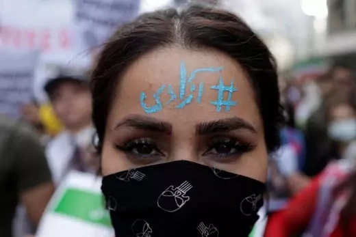 An Iranian woman living in Turkey with "Freedom" written on her forehead, takes part in a protest following the death of Mahsa Amini, near the Iranian consulate in Istanbul, Turkey October 4, 2022.
