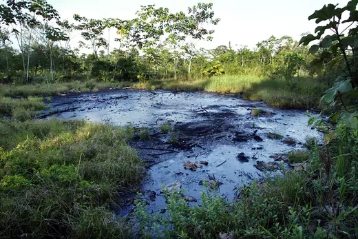 A waste pit filled with crude oil left by Texaco drilling operations lies near the Amazonian town of Sacha, Ecuador.