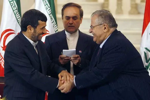 Iraqi President Jalal Talabani (R) shakes hands with Iranian President Mahmoud Ahmadinejad upon his arrival in Baghdad.