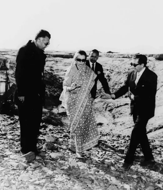Indian Prime Minister Indira Gandhi, center, examines a piece of rock at the nuclear test site in Pokhran, southeastern India.