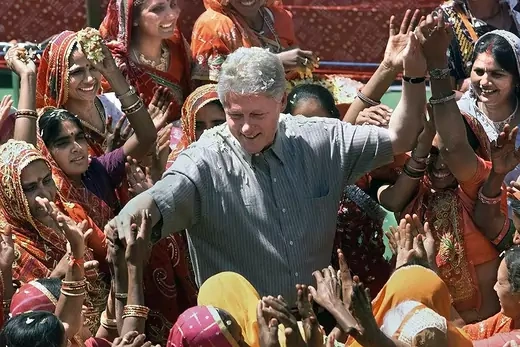 President Clinton reaches out to residents of Nayla, India.