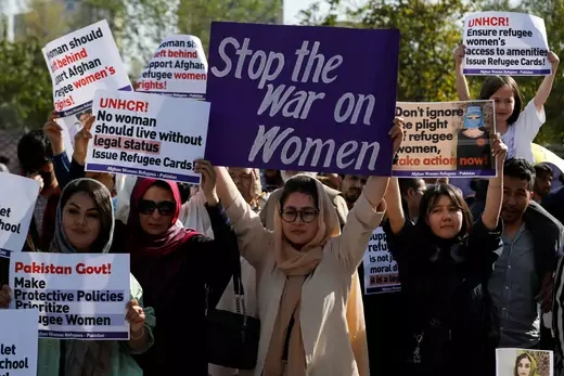 Afghan women refugees carry signs, as they participate in "Aurat March" or "Women's March," to mark International Women's Day, in Islamabad, Pakistan March 8, 2023.