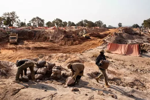 Miners move bags of cobalt inside the CDM (Congo DongFang Mining) Kasulo mine.