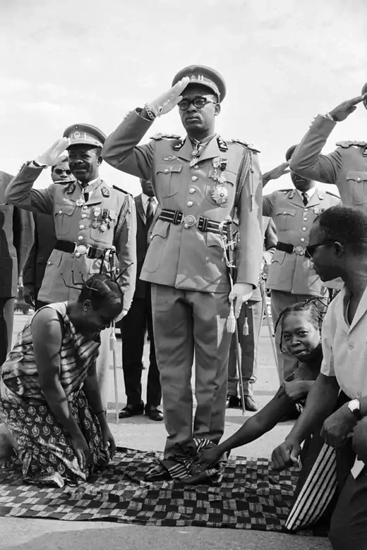 General Joseph-Désiré Mobutu has his shoes polished at the opening ceremonies of Parliament.
