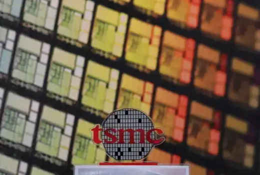 The logo of Taiwan Semiconductor Manufacturing Company (TSMC) can be seen alongside images of silicon chips in Hsinchu, Taiwan.