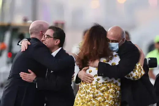 Formerly detained Iranian American dual citizens Siamak Namazi and Morad Tahbaz are embraced as they disembark in Doha, Qatar