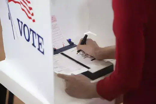 Person filling out election ballot