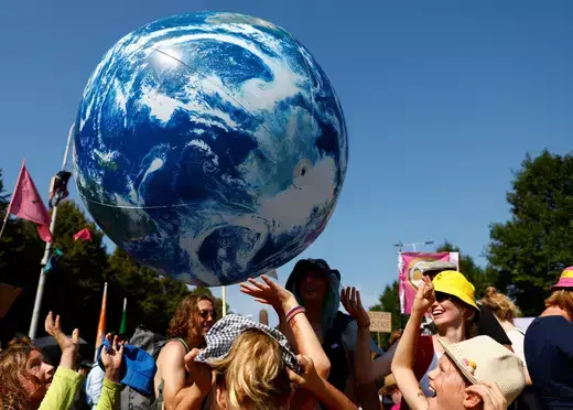 People play with an inflatable representation of the planet Earth in the Netherlands on September 9, 2023