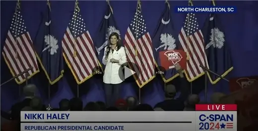 Haley as viewed standing in front of a row of U.S. and South Carolina flags.