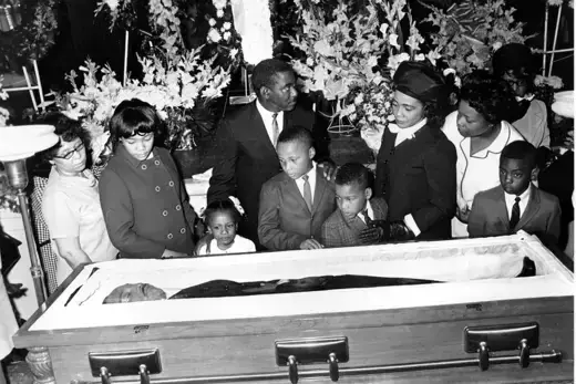 Reverend Martin Luther King Jr.’s body is viewed by his wife, Coretta Scott King, and their four young children look at King in his coffin at his funeral in Atlanta.
