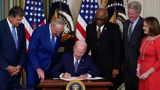 President Joe Biden signs the Inflation Reduction Act in the State Dining Room of the White House in Washington on August 16, 2022.