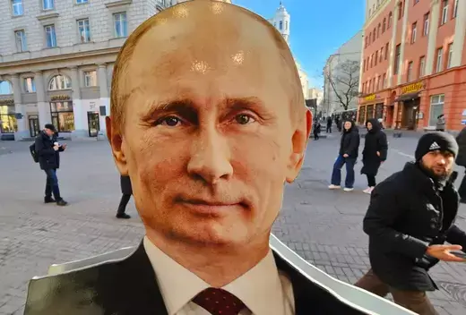 People walk past a cardboard cut-out of President Vladimir Putin displayed in a souvenir shop ahead of the upcoming elections for the President of Russia on March 14, 2024 in Moscow, Russia.