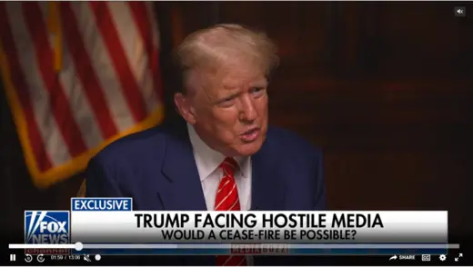 Trump as viewed speaking in front of the American flag. 