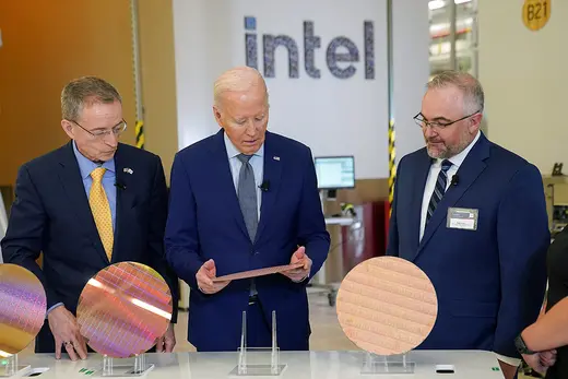 U.S. President Joe Biden looks at a semiconductor wafer, as he tours the Intel Campus in Chandler, Arizona, on March 20, 2024. 