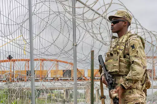 A member of the National Guard patrols the southern U.S. border in Eagle Pass, Texas.