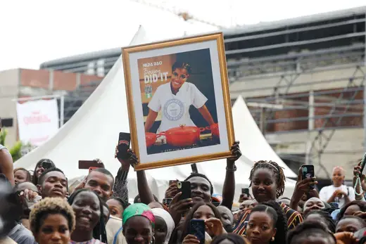 People cheer as Nigerian Chef Hilda Bassey attempts to break the Guinness World Record for the longest cooking time by an individual, in Lagos, Nigeria on May 15, 2023.