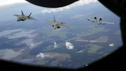 Two F-22 Raptor fighter jets of the 95th Fighter Squadron and an A-10 Thunderbolt (R) from Whiteman air force base, Missouri, approach the refueling nozzle of a KC-135 Stratotanker 