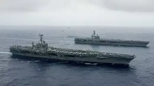 The Nimitz-class aircraft carriers USS John C. Stennis (CVN 74), and USS Ronald Reagan (CVN 76) (rear) conduct dual aircraft carrier strike group operations in the Indo-Asia-Pacific in Philippine Sea. 