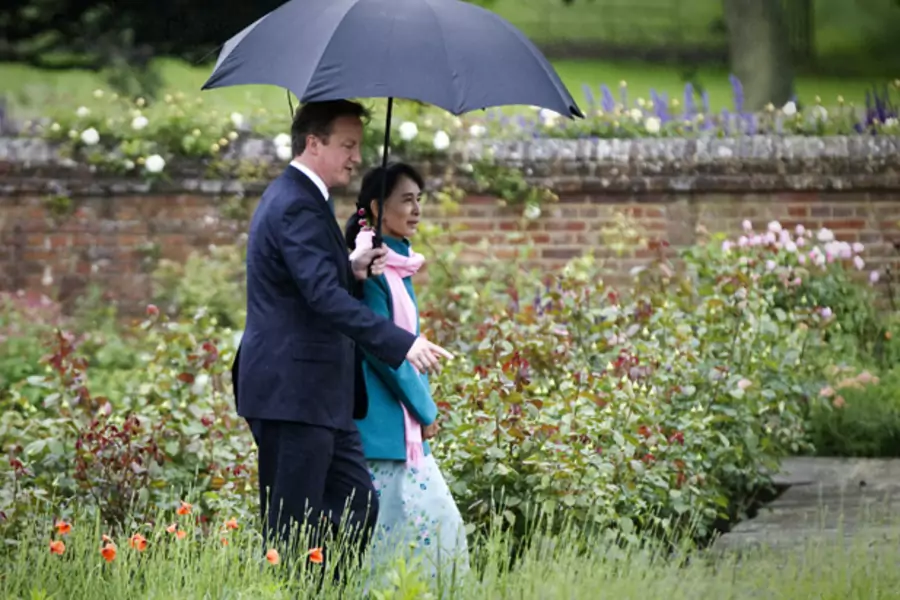 Britain's Prime Minister David Cameron and Myanmar pro-democracy leader Aung San Suu Kyi walk in the rose garden at Chequers, the Prime Minister's official country residence in Buckinghamshire, southern England June 22, 2012.