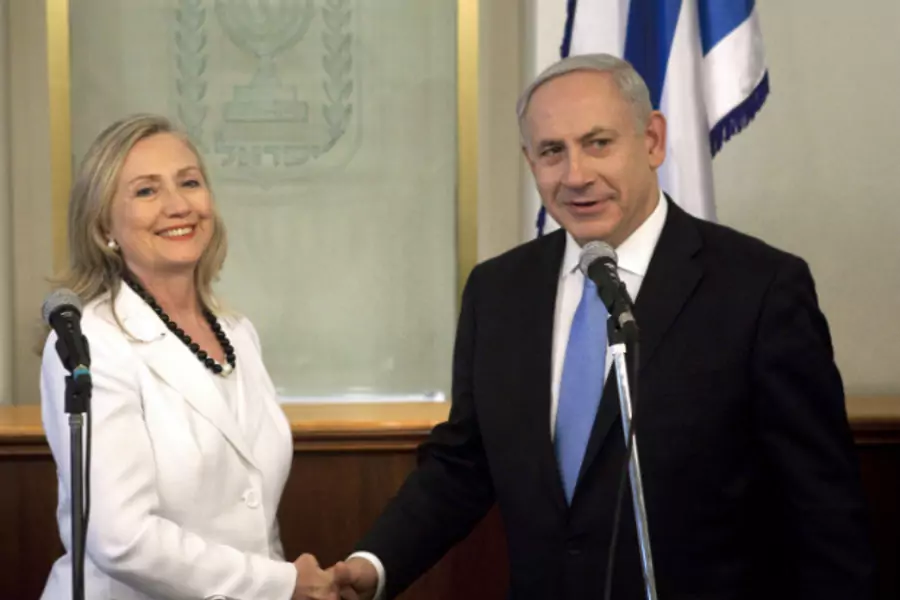 Israel's Prime Minister Benjamin Netanyahu and U.S. Secretary of State Hillary Clinton shake hands during their meeting in Jerusalem July 16, 2012 (Courtesy REUTERS/Abir Sultan/Pool).