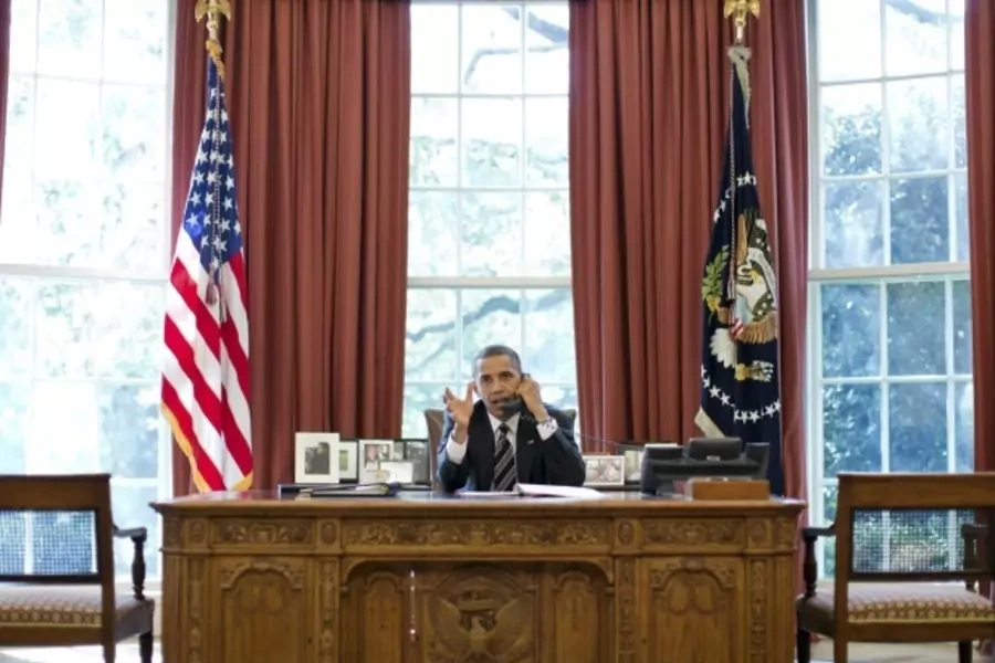 U.S. President Obama speaks on the phone at the White House (Handout/Courtesy Reuters).