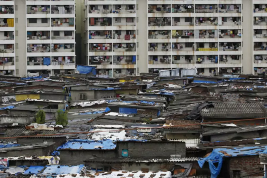 High rise residential buildings are seen behind a slum in Mumbai on July 20, 2010 (Danish Siddiqui/Courtesy Reuters.