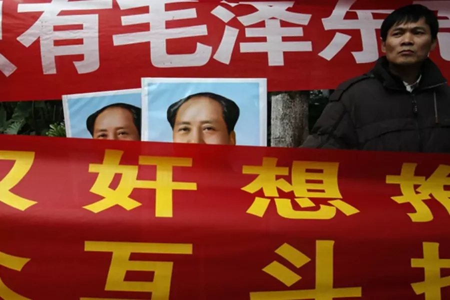 Leftists displaying banners and portraits of the late Chinese leader Mao Zedong demonstrate outside the office of the liberal ...e southern Chinese city of Guangzhou January 9, 2013, denouncing the newspaper as "a traitor newspaper" for defying the party.