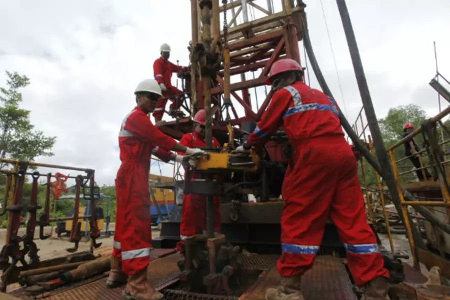 PT Pertamina workers repair an old oil well for reactivation in Tarakan, Indonesia's East Kalimantan province, on February 9, 2011 (Beawiharta Beawiharta/Courtesy Reuters).