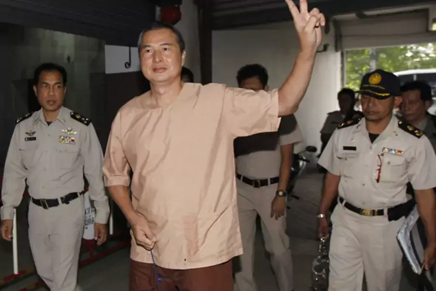 Somyot Prueksakasemsuk (C), editor of "Voice of the Oppressed", a magazine devoted to self-exiled former Prime Minister Thaksin Shinawatra, gestures as he arrives at the criminal court in Bangkok January 23, 2013.