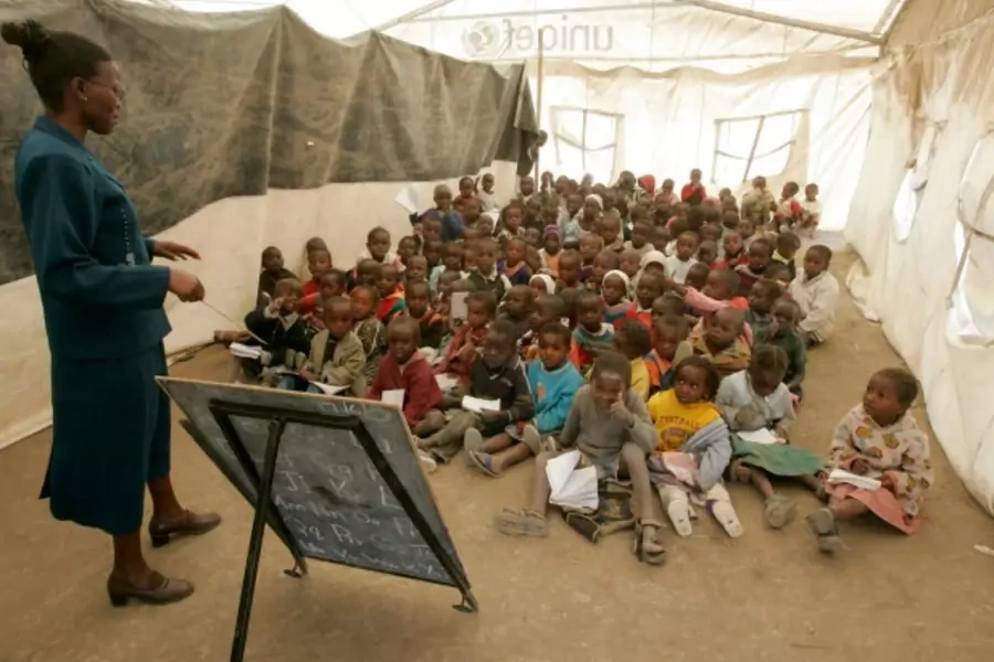 Children listen to their teacher during a lesson at a camp for internally displaced people in Naivasha, Kenya, June 2008 (Courtesy Reuters/Antony Njuguna).