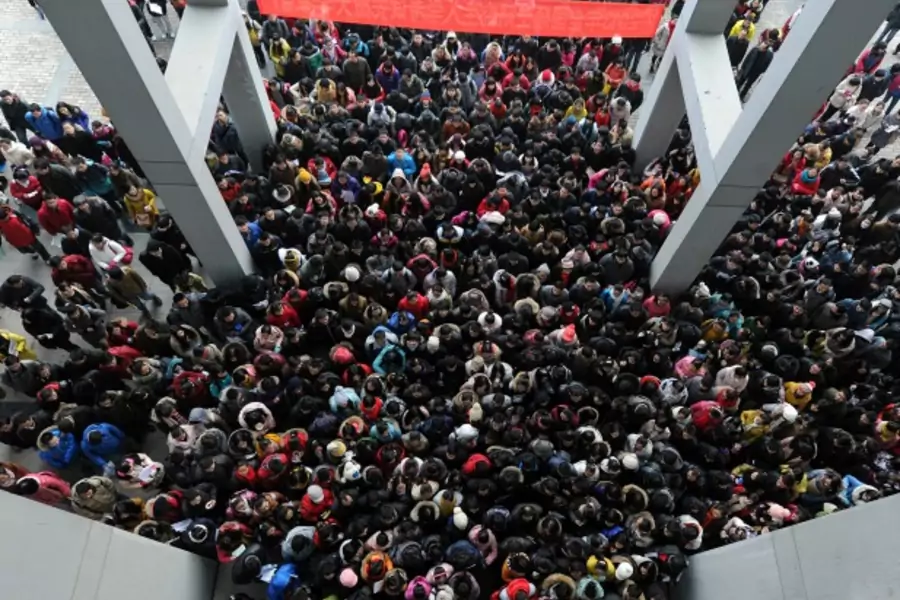 Examinees walk into the entrance of a classroom building to take part in a three-day entrance exam for postgraduate studies, at Anhui University, in Hefei, Anhui province on January 5, 2013 (Stringer/Courtesy Reuters).