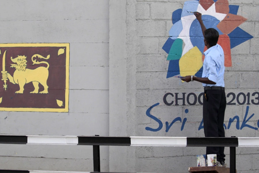 A man paints the logo of CHOGM 2013, ahead of the upcoming Commonwealth Heads of Government Meeting (CHOGM) 2013, in Colombo, November 11, 2013