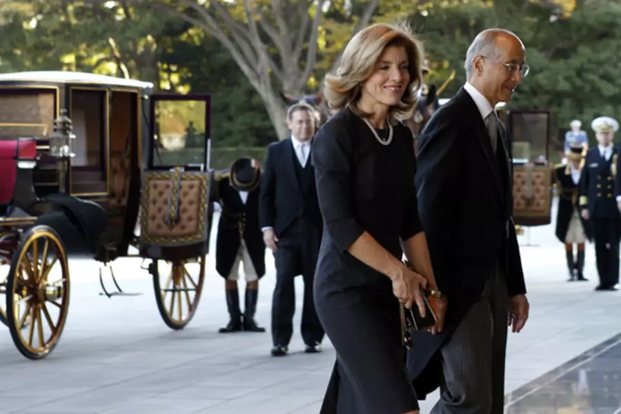 Newly appointed U.S. ambassador to Japan Caroline Kennedy (L) is escorted by protocol chief Nobutake Odano as she arrives at the Imperial Palace by horse-drawn carriage in Tokyo, November 19, 2013