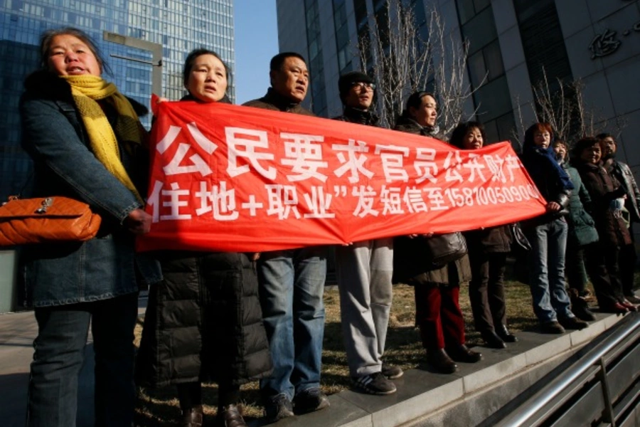 Supporters of Xu Zhiyong, one of China's most prominent rights advocates, shout slogans near a court where Xu's trial is being held, in Beijing on January 22, 2014. (Kim Kyung-hoon/Courtesy Reuters)