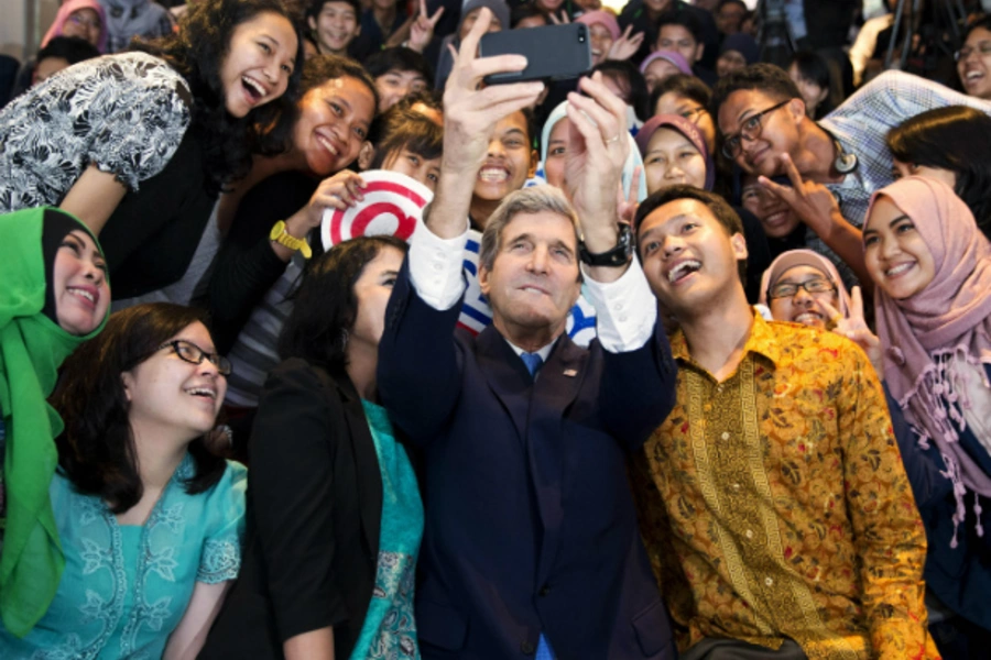 U.S. Secretary of State John Kerry takes a selfie with a group of students before delivering a speech on climate change in Jakarta on February 16, 2014. (Pool New/Courtesy Reuters)