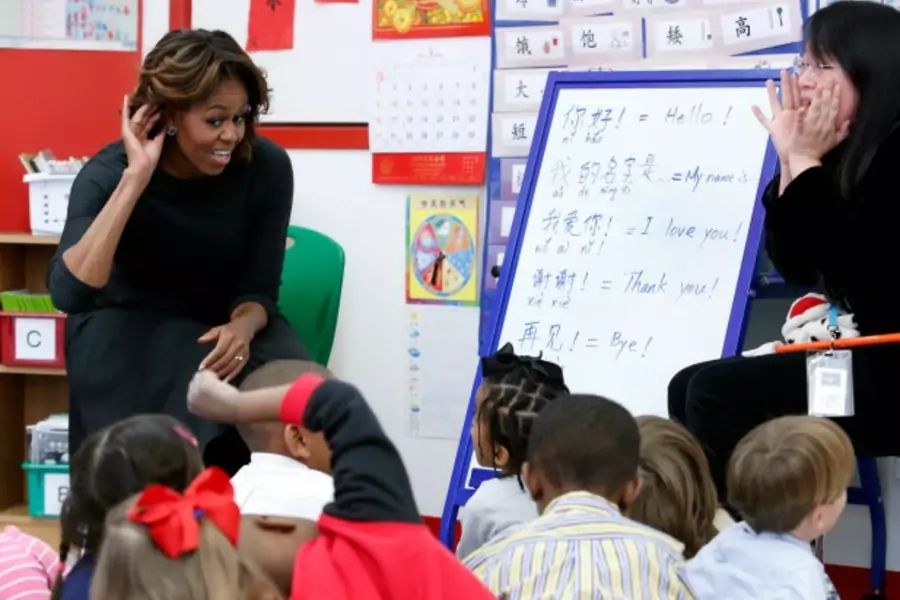 U.S. first lady Michelle Obama (L) participates in a language class with teacher Crystal Chen for pre-school students at the W...Ying Public Charter School ahead of her upcoming trip to China, in Washington on March 4, 2014. (Yuri Gripas/Courtesy Reuters)