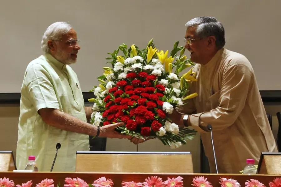 Narendra Modi (L), the prime ministerial candidate for India's main opposition Bharatiya Janata Party (BJP), receives a bouque...party leaders and workers at Gandhinagar in the western Indian state of Gujarat on May 13, 2014 (Amit Dave/Courtesy: Reuters).