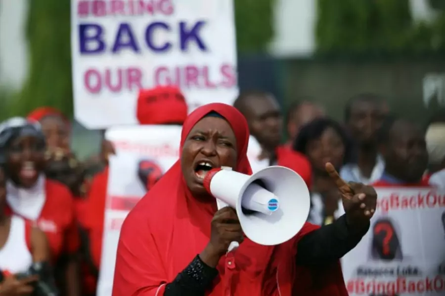A protester addresses the "Bring Back Our Girls" protest group as they march to the presidential villa to deliver a protest le...hoolgirls in Chibok who were kidnapped by Islamist militant group Boko Haram, May 22, 2014 (Courtesy Reuters/Afolabi Sotunde).