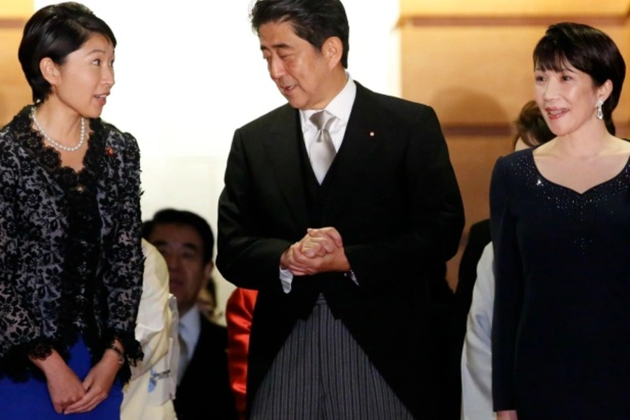Japan's Prime Minister Shinzo Abe (C) talks with Economy, Trade and Industry Minister Yuko Obuchi (L) and Internal Affairs and...chi as they prepare for a photo session at his official residence in Tokyo on September 3, 2014. (Toru Hanai/Courtesy Reuters)