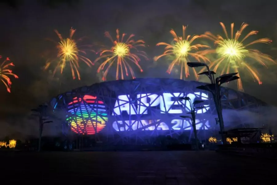 Fireworks explode over a screen displaying the APEC logo on the National Stadium, or the "Bird's Nest", during a rehearsal for...it in Beijing, November 4, 2014. Picture taken November 4, 2014. REUTERS/Stringer (CHINA - Tags: POLITICS BUSINESS) CHINA OUT.