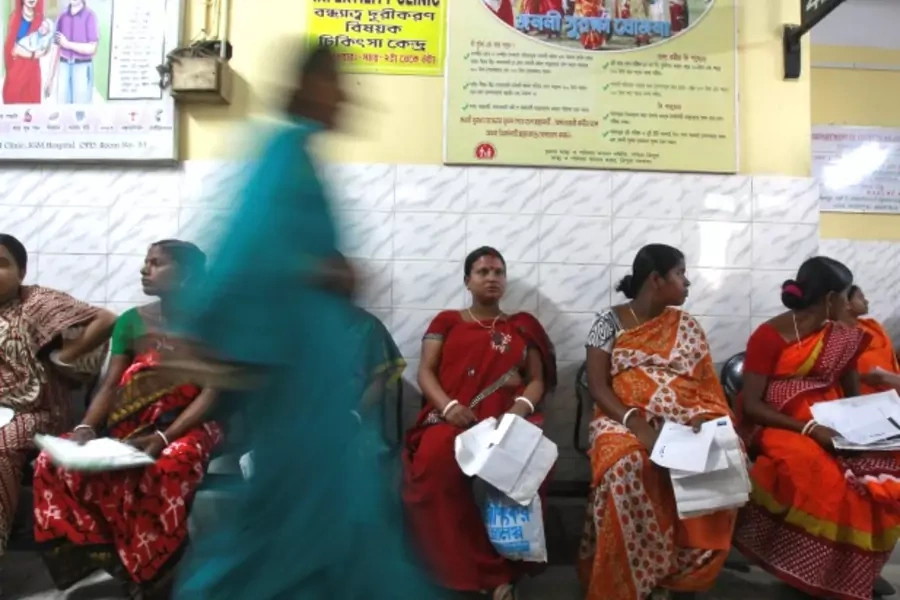 Pregnant women holding their prescription papers wait to be examined at a government-run hospital in the northeastern Indian c...ions, to reach places where health workers rarely go. REUTERS/Jayanta Dey (INDIA - Tags: HEALTH SCIENCE TECHNOLOGY) - RTR4TMSZ