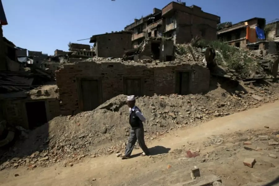 A man walks past the debris of collapsed houses in Bhaktapur, Nepal October 5, 15. Twin earthquakes in April and May killed almost 9,000 people in Nepal's worst natural disaster (Reuters/Navesh Chitrakar).